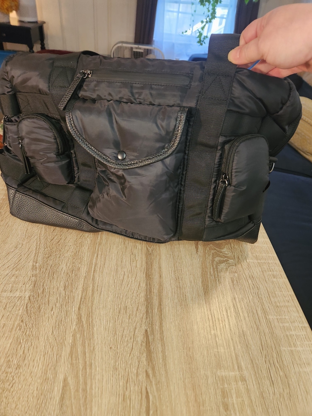 Tommy Bahama black Nylon and leather Weekender Bag featuring a trolley sleeve.